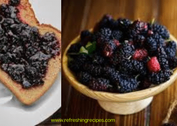 A slice of bread with dark berry jam, possibly made from mulberries, sits next to a bowl filled with fresh blackberries and a small jar of jam on a wooden surface.