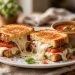 Caprese grilled cheese sandwich with melted mozzarella oozing out, served with tomato soup