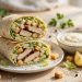 Chicken Caesar wraps cut in half showing grilled chicken, romaine lettuce and creamy Caesar dressing inside soft tortillas