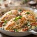 Creamy garlic Tuscan chicken with sun-dried tomatoes and spinach in a cast-iron skillet