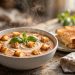 Creamy tomato basil soup in a rustic bowl topped with crispy grilled cheese croutons, fresh basil, and a swirl of cream