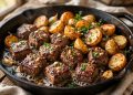 Garlic butter steak bites and crispy baby potatoes in a cast iron skillet with parsley