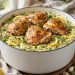 One-pot lemon herb chicken and orzo with chicken thighs, lemon slices, and fresh herbs