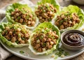 Asian chicken lettuce wraps in butter lettuce cups with hoisin dipping sauce