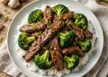 Beef and broccoli stir-fry with glossy garlic-ginger sauce served over steamed rice