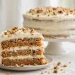 Slice of layered carrot cake with cream cheese frosting