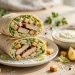 Chicken Caesar wraps cut in half showing grilled chicken, romaine lettuce and creamy Caesar dressing inside soft tortillas