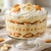 Classic banana pudding in a glass trifle dish with vanilla wafers and banana slices
