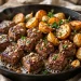 Garlic butter steak bites and crispy baby potatoes in a cast iron skillet with parsley