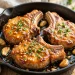 Honey garlic glazed pork chops in a skillet with fresh parsley