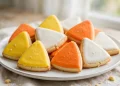 Candy corn sugar cookies in white orange and yellow wedges