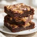 Peanut butter swirl brownies stacked showing marbled tops