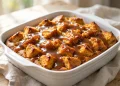 Pumpkin bread pudding with warm caramel sauce drizzled over the top