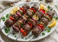 Grilled Mediterranean beef kebabs with peppers, onion and zucchini on a platter