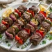 Grilled Mediterranean beef kebabs with peppers, onion and zucchini on a platter