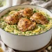 One-pot lemon herb chicken and orzo with chicken thighs, lemon slices, and fresh herbs
