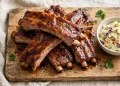 Oven-baked BBQ pork ribs with glossy caramelized sauce on a wooden board