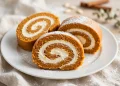 Sliced pumpkin roll with cream cheese filling showing the spiral swirl