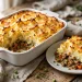 Shepherd's pie with golden mashed potato topping in a white baking dish